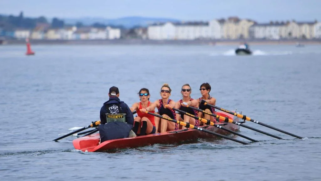 Coastal rowing crew on open water